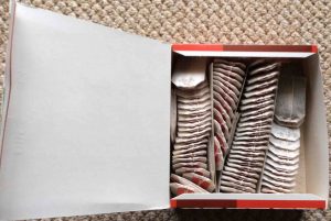 Picture of an open box of Salada Pekoe Cut Black Tea, showing the teabags, tags, and strings. 